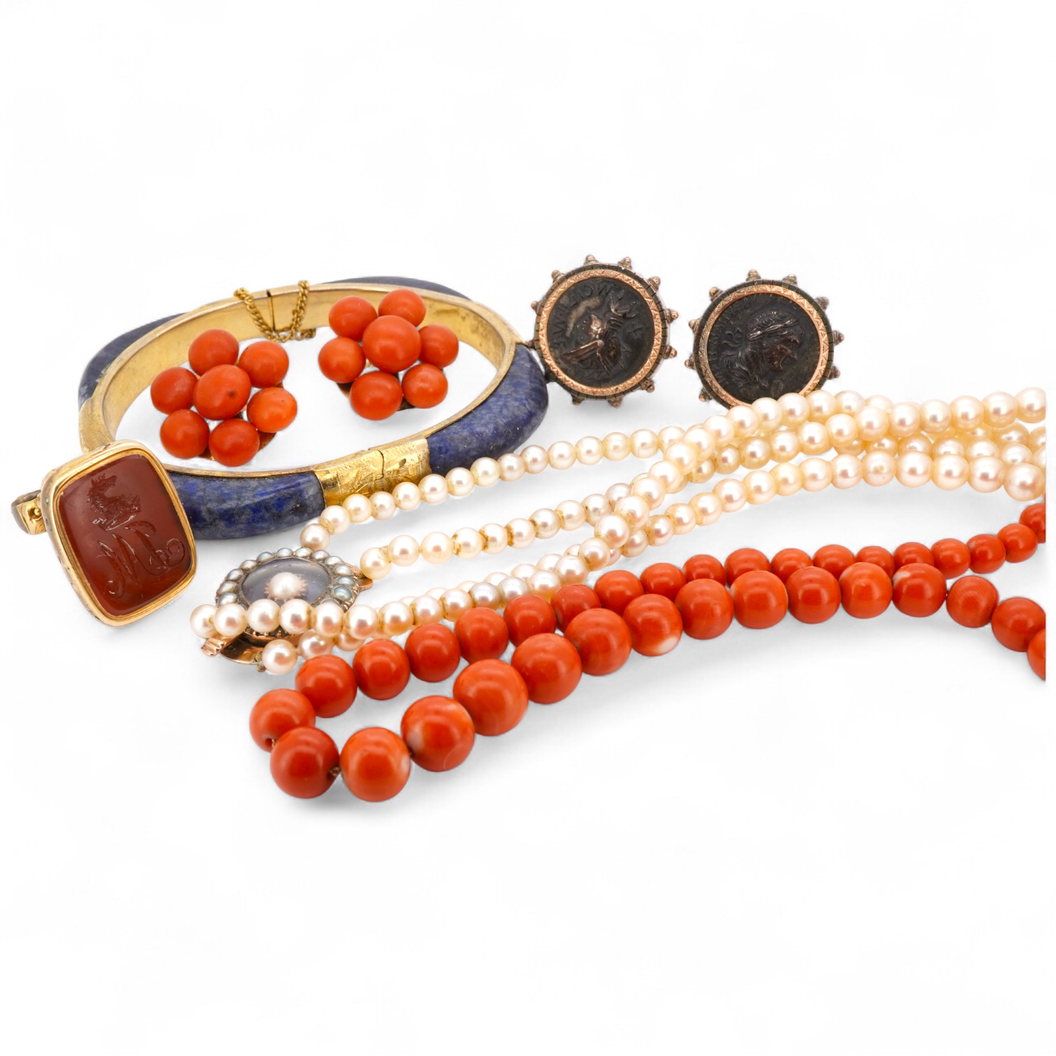 A collection of jewels including a coral demi-parure, comprising: a coral necklace and pair of earrings, lengths 46 and 2.5cm respectively, necklace clasp stamped 14K, earrings with post fittings; a carnelian fob seal wi